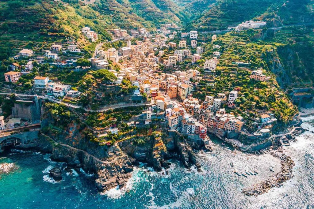 The colorful houses of Riomaggiore glowing under the sun, overlooking the Mediterranean.